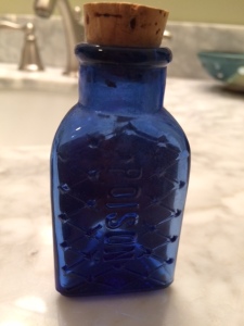 The word "poison" is etched into the bottle. 